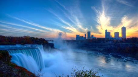 Majestic Urban Waterfall at Dusk wallpaper