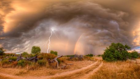 Electric Fury Over Tranquil Fields wallpaper