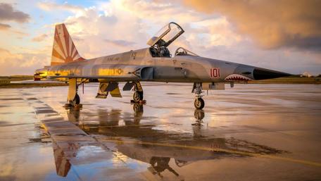 Fighter Jet on a Rainy Sunset Runway wallpaper