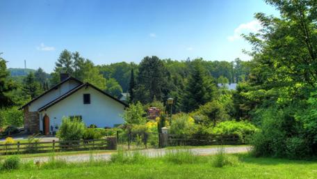 Serene Cottage Amidst Lush Greenery wallpaper