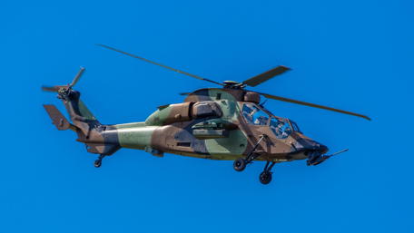 Dynamic Military Helicopter in Action Above Blue Sky wallpaper