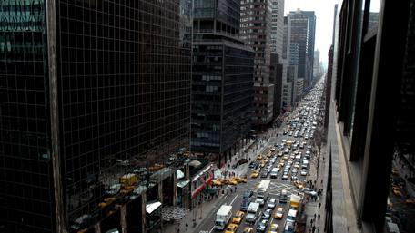 Bustling City Traffic Scene Amidst Skyscrapers wallpaper