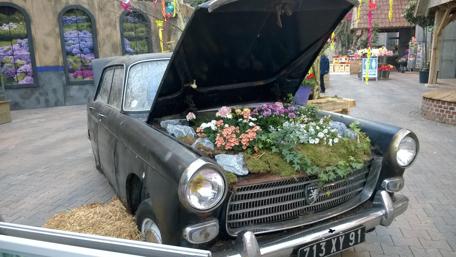 Vintage Car Transformed into a Floral Garden Display wallpaper