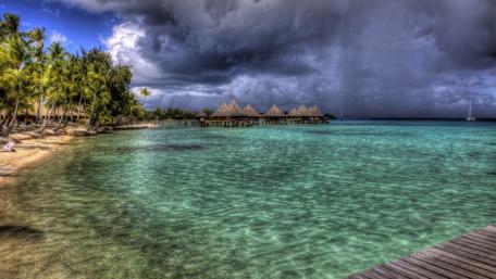 Tropical Paradise Under Darkening Skies wallpaper