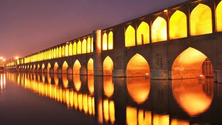 Golden Arches over Serene Waters in Evening City wallpaper