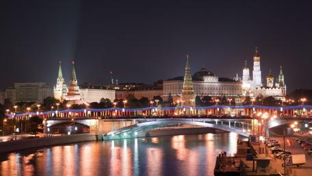 Cityscape at Night with Glimmering Lights and Reflection wallpaper