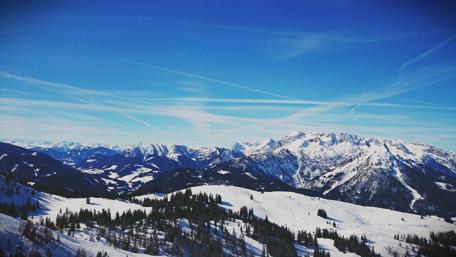 Majestic Snow-Capped Mountains Under a Clear Blue Sky wallpaper