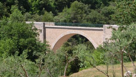 Scenic Bridge Surrounded by Lush Greenery wallpaper