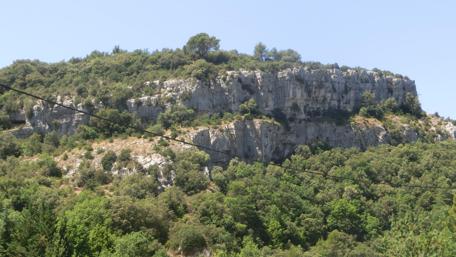 Majestic Rocky Hill Surrounded by Lush Greenery wallpaper