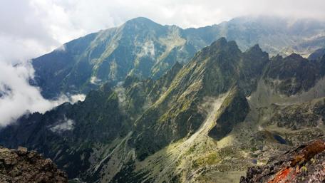 Majestic Mountain Peaks Surrounded by Clouds wallpaper