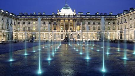 Majestic City Lights and Fountain Display wallpaper