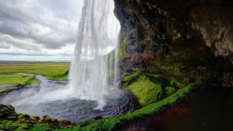 Majestic Waterfall Hidden in a Cave Scene wallpaper