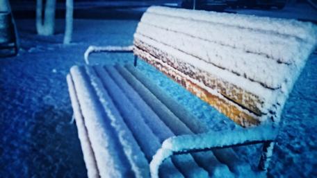 Winter's Embrace on a Snowy Bench wallpaper