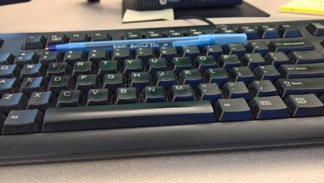 Sleek Black Keyboard on a Workspace wallpaper