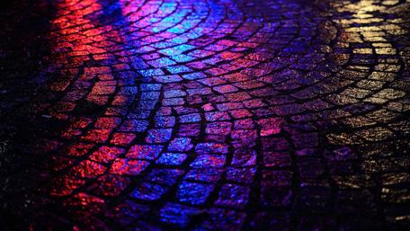 Vibrant Cobblestone Path Under Night Lights wallpaper