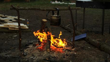 Cozy Campfire in a Russian Forest Scene wallpaper