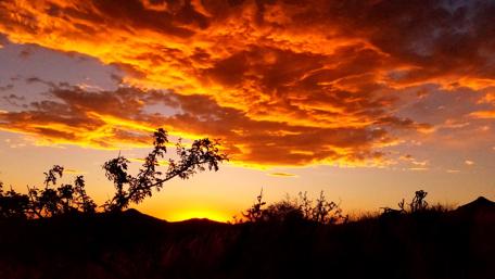 Fiery Sunset Over Rolling Hills wallpaper