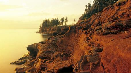 Golden Sunset Over Rugged Cliffs and Still Waters wallpaper