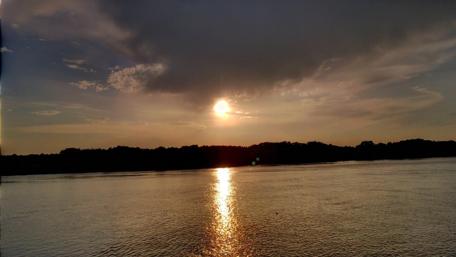 Serene Sunset Over Tranquil River Waters wallpaper