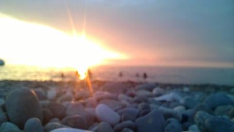 Tranquil Sunset Over Pebbled Beach wallpaper