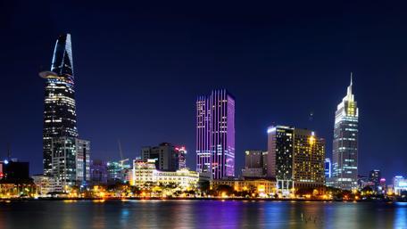 Stunning Cityscape at Night with Skyscrapers and Water Reflection wallpaper