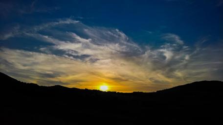 Breathtaking Sunset Over Rolling Hills wallpaper