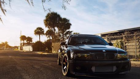 Sleek Black BMW on a Sunset Street wallpaper