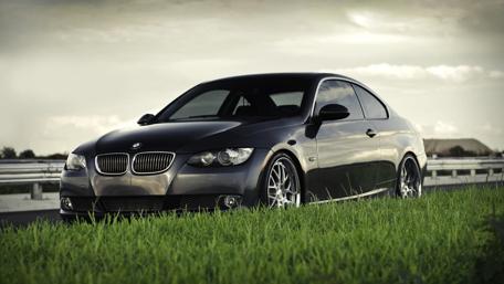 Sleek Black BMW on Open Road wallpaper