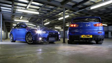 Sleek Blue Cars in an Industrial Setting wallpaper