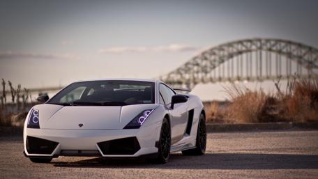 Sleek White Lamborghini Underneath a Bridge Scene wallpaper