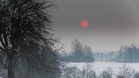 Ethereal Winter Sunset Over a Snowy Landscape wallpaper