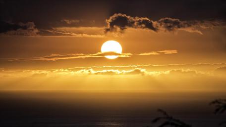 Golden Horizon Amidst Clouds and Ocean Waves wallpaper