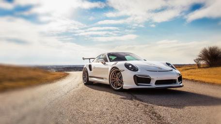 Sleek Dream Car on an Open Road wallpaper