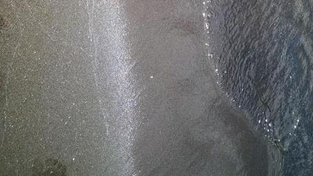 Shimmering Waves Meeting Sandy Shores wallpaper