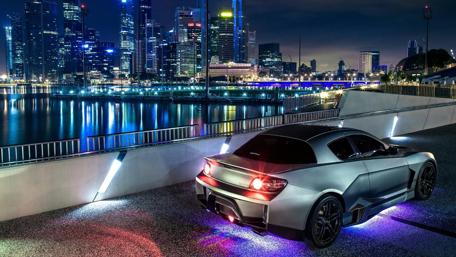 Sleek Dream Car Against a City Skyline wallpaper