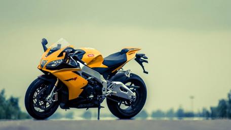 Sleek Yellow Sports Bike on the Asphalt Road wallpaper