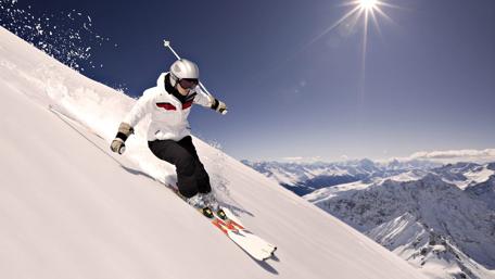 Thrilling Ski Adventure in Majestic Mountains wallpaper