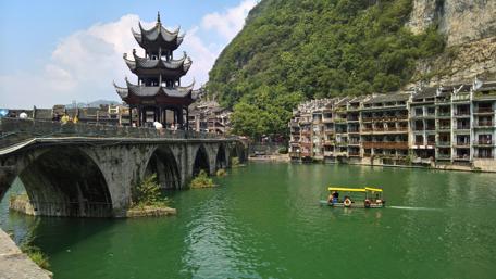 Serene Cityscape with Traditional Architecture and River View wallpaper