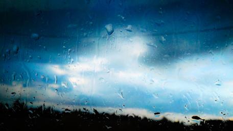 Serene Winter Rain Through a Window wallpaper