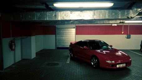 Sleek Red Toyota Sports Car in Parking Garage wallpaper