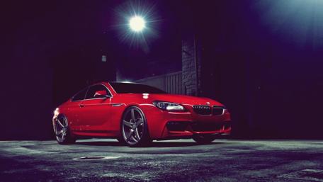 Sleek Red BMW in Urban Night Scene wallpaper