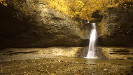 Golden Autumn Waterfall Scene wallpaper