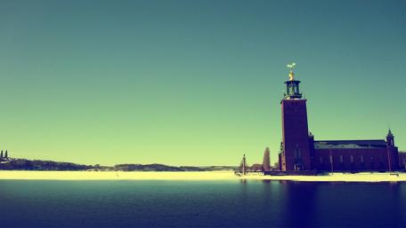 Serene Lighthouse Overlooking a Frozen Lake wallpaper