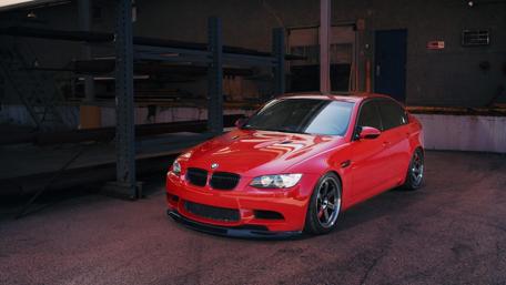 Vibrant Red BMW M3 in Urban Setting wallpaper