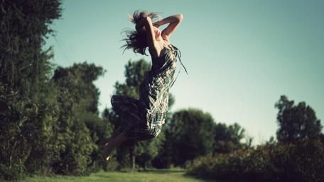 Joyful Leap in Nature's Embrace wallpaper