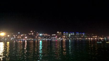 Nighttime City Lights Reflected in Water wallpaper