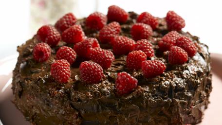 Delicious Chocolate Cake with Raspberries Displayed Beautifully wallpaper