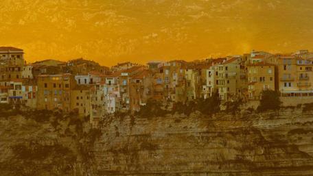 Golden Cityscape Overlooking Rocky Terrain wallpaper
