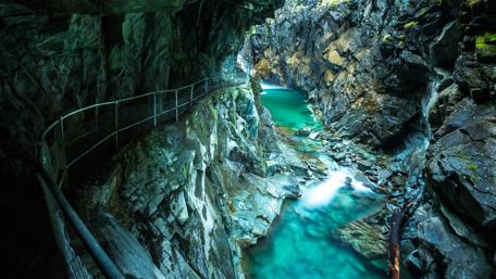 Serene River Coursing Through Rocky Cavern wallpaper
