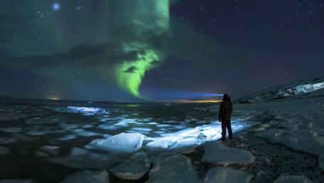 Majestic Aurora Over Icy Landscape wallpaper